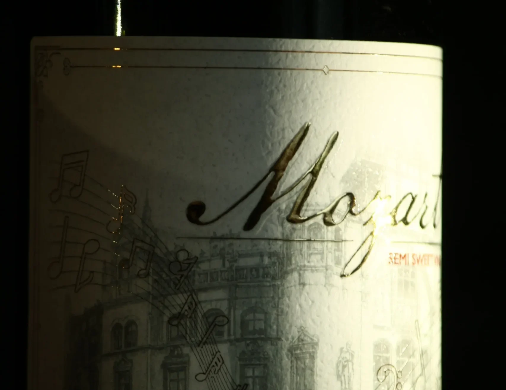 Premium-class silk foil labels with metallic shine and embossed design on a beverage bottle.