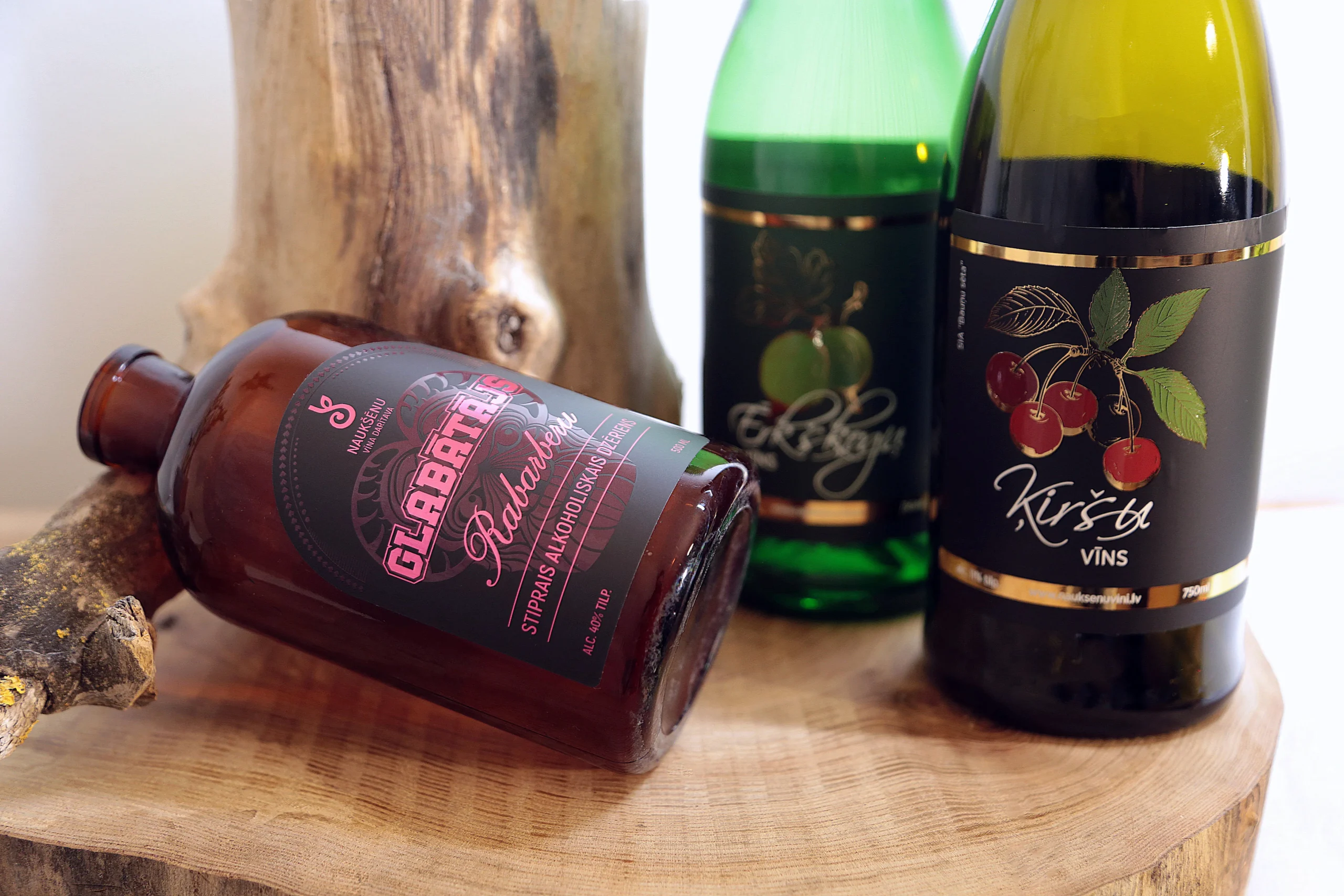 Three beverage bottles with decorated labels, showcasing premium label designs with foil stamping and varnish effects.